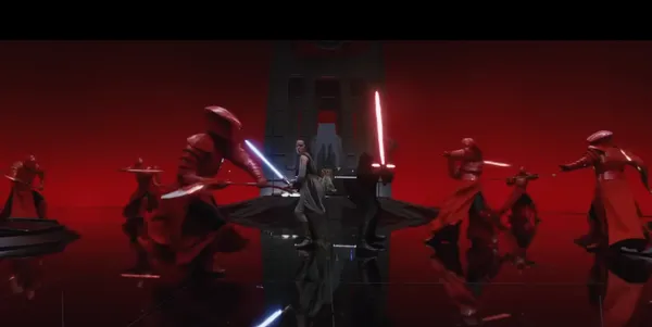 Dramatic lightsaber battle in a striking red room.