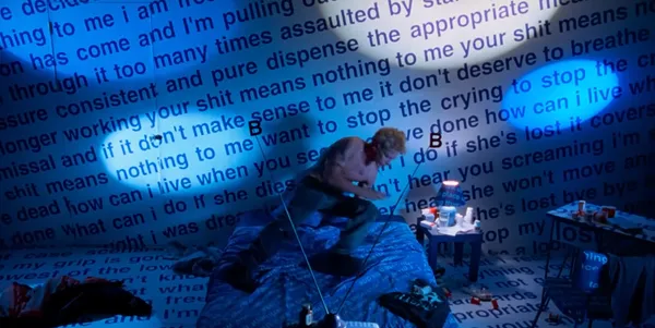 A chaotic room with a person in intense motion surrounded by large text.