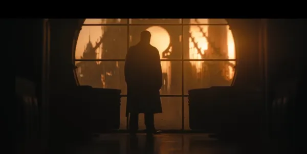 Silhouette of a figure against a sunset in a futuristic setting.