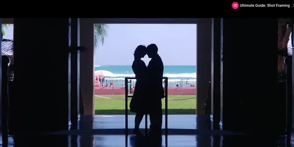 Silhouette of a couple embracing with a beach background.