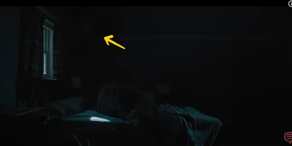 A dimly lit room with a single source of natural light from a window.