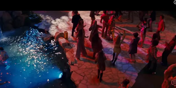 A vibrant party scene with people dancing near a pool.