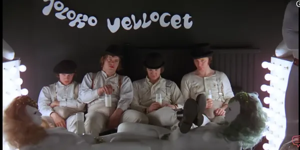 Four people sitting in a stylized bar setting with unique decor.