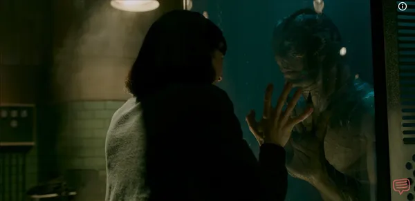 A woman tenderly touching the glass of a dark water tank holding a humanoid creature