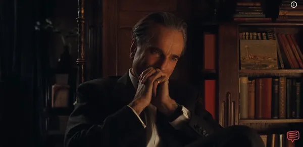 An intense man deeply focused in thought in a dimly lit, wood-paneled room