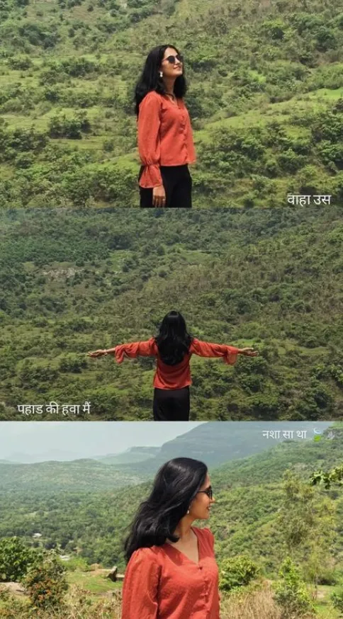 Person enjoying nature with a scenic mountainous background.