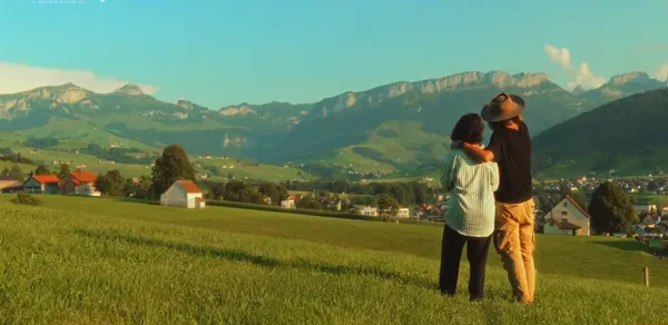 A couple is admiring a picturesque mountain view.