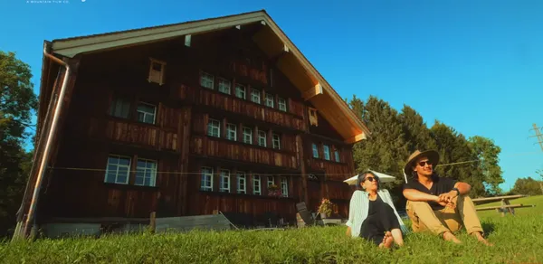 A relaxed moment in front of a rustic wooden house.