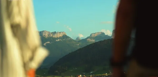 Two people admiring a scenic mountain view.