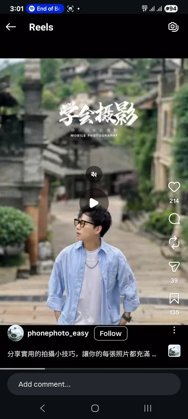 A person walking through a traditional village setting.