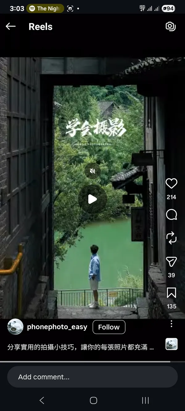 A person standing and looking at a scenic river view through a corridor.