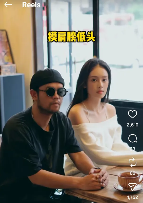 Two people sitting at a table in a cafe.