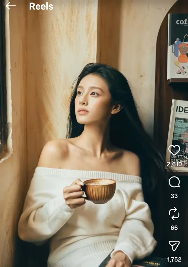 A person gazes out the window holding a cup of coffee.