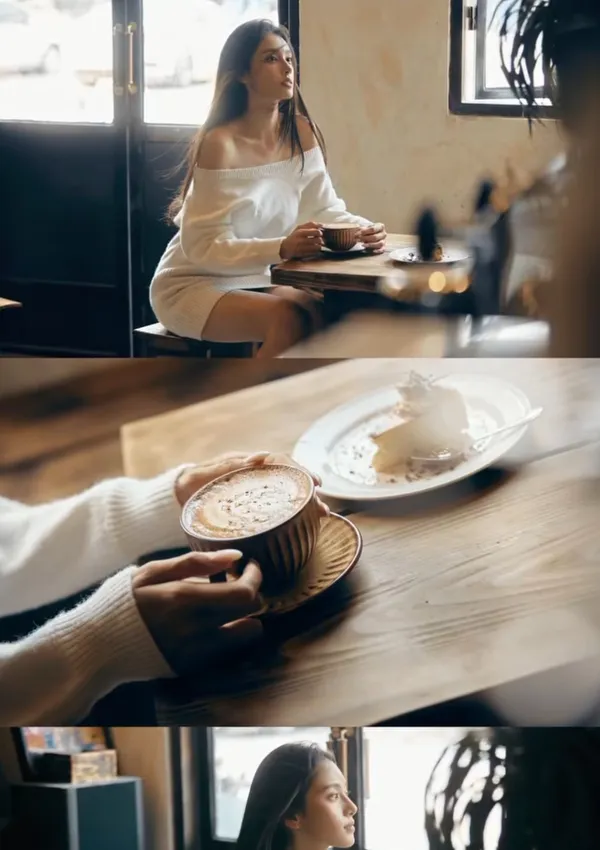 A person enjoying coffee in a cozy cafe setting.