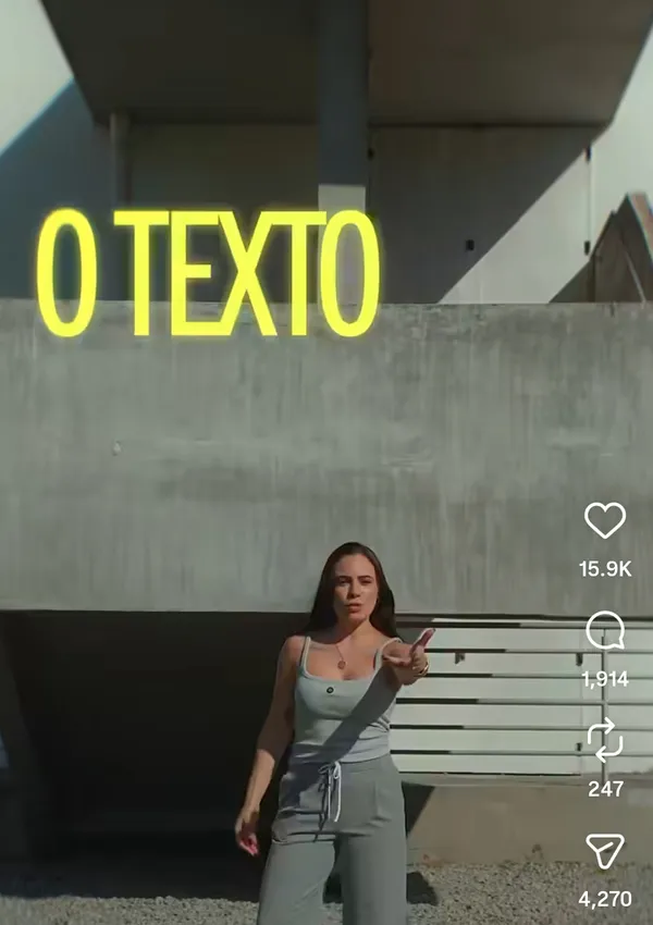 A woman gestures towards the camera with a building in the background.